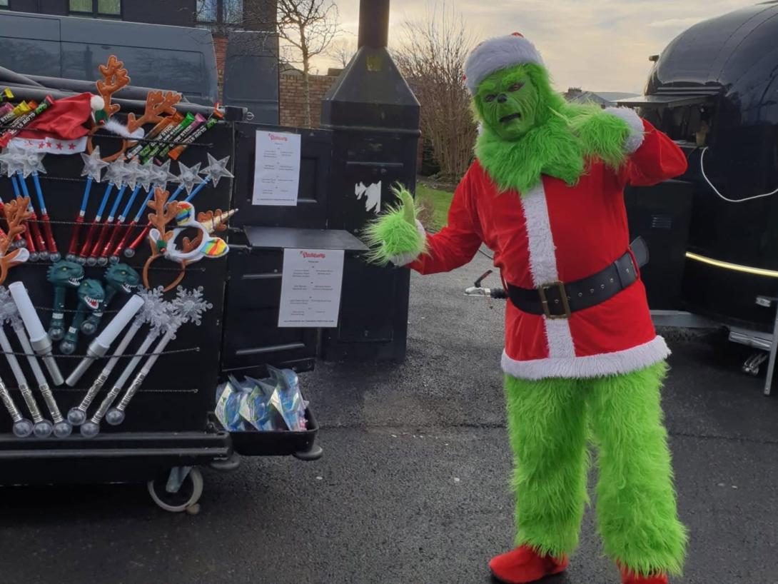 A Grinch in a Santa suit, ready for the parade